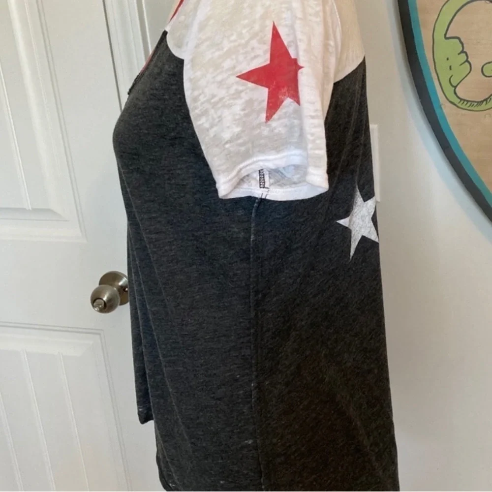 Distressed look top with asymmetrical hem chaser star top